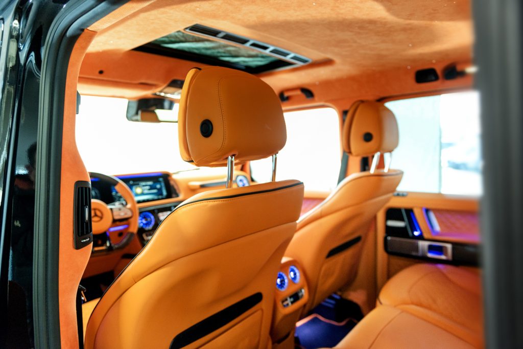 Lyxig interiör i en Brabus G63 modifierad med Hermes-design, orange läderklädsel och exklusiva detaljer.